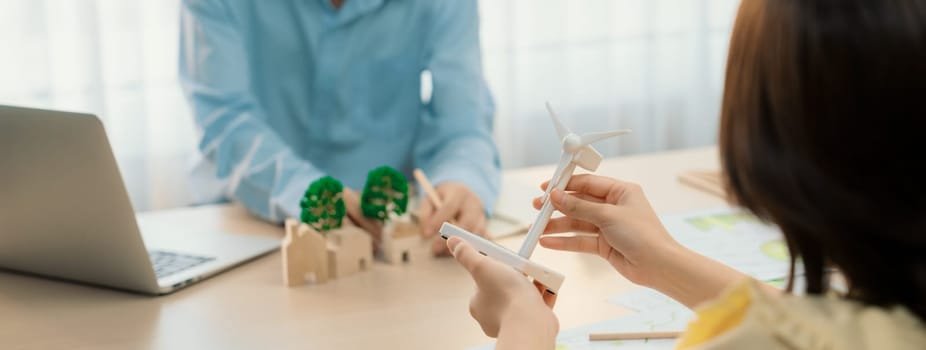 Businesswoman interested in investing in renewable energy at meeting table with environmental document scatter around. Business team discussion about green business project. Closeup. Delineation.