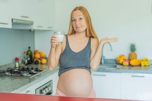 Weighing the pros and cons of milk during pregnancy, a thoughtful pregnant woman stands in the kitchen with a glass, contemplating the decision to include or avoid milk for her and her baby's well-being.