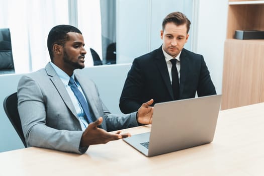 Cooperative handsome african businessman present start up project while manager listen and decide to invest. Two businesspeople making agreement, reporting data. Multicultural business. Ornamented.