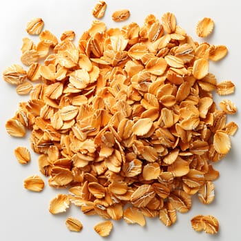 Rolled oats, a staple food ingredient, are a type of seed from the oat plant. They are commonly used in cuisine to produce breakfast cereal dishes. A pile of oats rests on a white surface