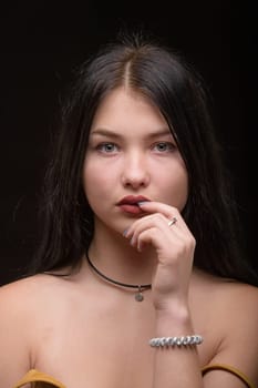 Studio portrait of a young beautiful girl with long hair