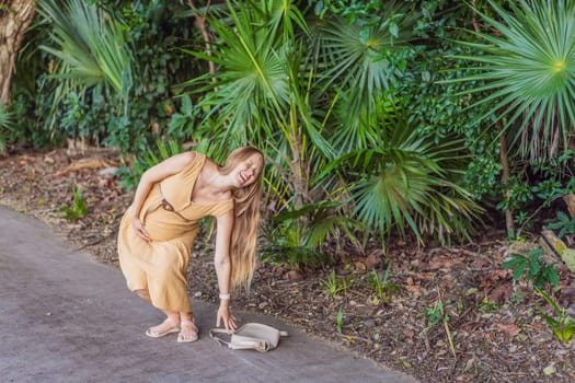 pregnant woman drops her keys and struggles to pick them up, highlighting the physical limitations that can arise during pregnancy. Patience and support become essential.