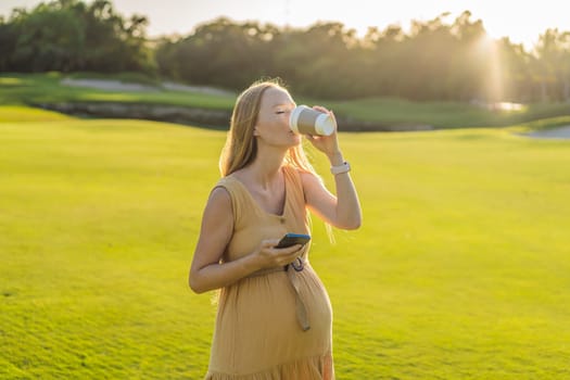 pregnant woman enjoys a cup of coffee outdoors, blending the simple pleasures of nature with the comforting warmth of a beverage during her pregnancy.