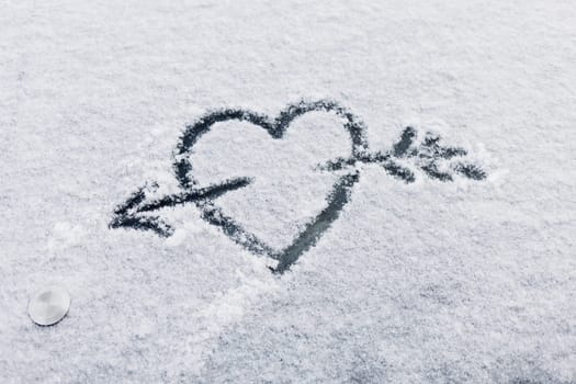 heart in the snow with an arrow is a symbol of eternal love and celebration - Valentine's Day