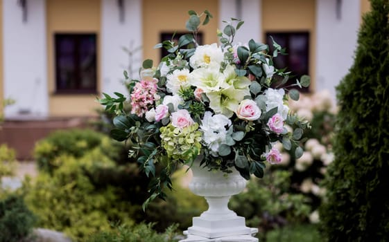 Beautiful bouquet of roses in a vase on wedding day. Beautiful set up for the wedding ceremony.