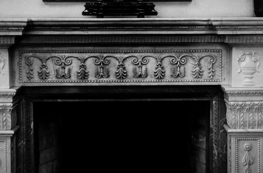fireplace in castle. Classic decor of exquisite fireplace with ornamental elements in old mansion house