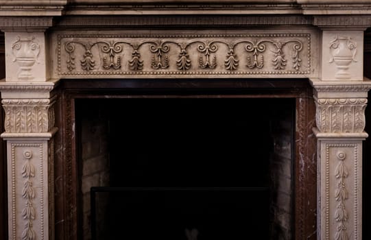 Rich interior with antique fireplace with stucco in vintage room