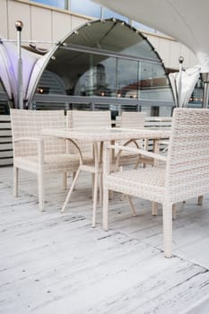 cozy outdoor cafe with light chairs.