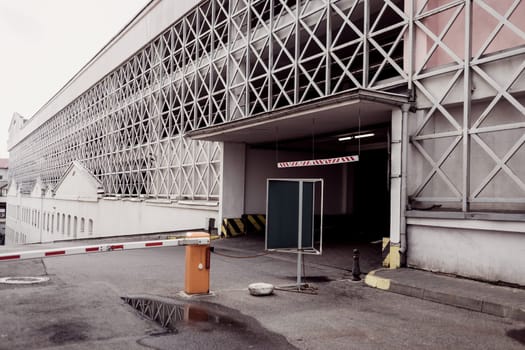 the road near the city parking lot with a barrier
