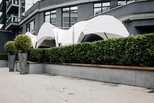 outdoor terrace of the restaurant is hidden by green thuja. cafe near the hotel