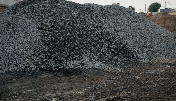 hills of stones for construction industrial. Pile rocks or gravel gray stone textures asphalt mix concrete in road constructions