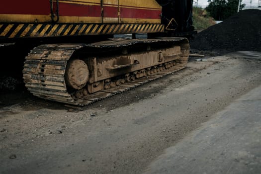 crawler backhoe. A crawler drive chassis of a heavy backhoe machine on a construction site. 