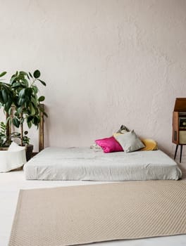Beautiful loft bedroom with bed near rough wall 