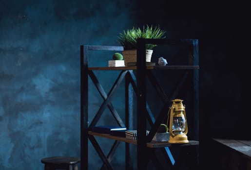 contemporary loft interior with shelves full of decor objects on the blue wall