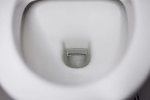 porcelain toilet bowl with water.