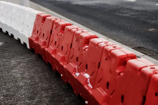 Red and white plastic barriers blocking the road