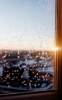 frost on the window and sunlight. sunrise