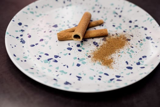 Ceylon cinnamon sticks on ceramic plate. spice