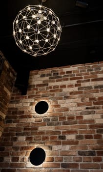 luminous stylish pendant lamp in the loft interior
