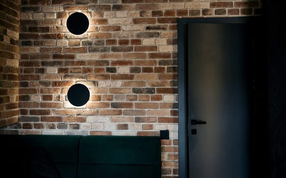 brick wall with lamps in the loft of an office or apartment