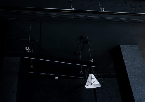 Hanging lamps in loft style on the background of rough cement plaster on the ceiling.