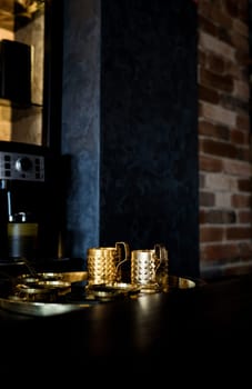 golden retro coffee cups in loft interior. vintage cafe