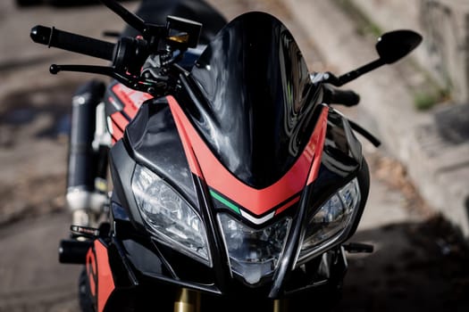 Headlight of the black sports motorcycle.