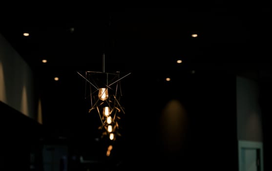 Minimalistic lamps decorated cafe in a modern loft style. Yellow color light.