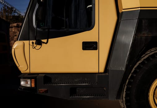 Yellow truck crane on construction site