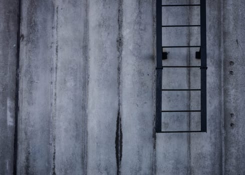 concrete wall with ladder. space for text. rough texture