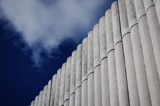 Abstract concrete exterior, grungy walls under blue sky. urban scape