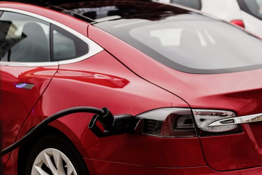 Charging an electric car with the power cable. zero emission into the atmosphere