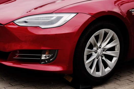 Headlights and hood of sport red car on parking