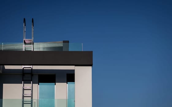 luxury villa with window and ladder over blue sky background