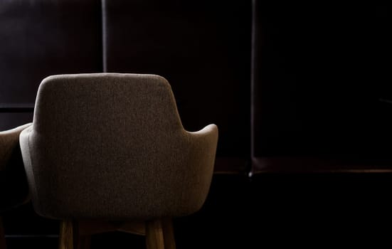 minimalistic dark interior of a cafe with an armchair