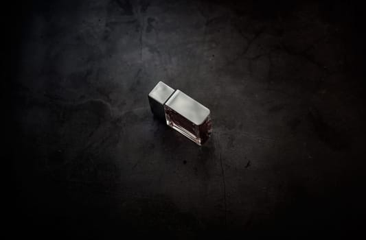 fragrance perfume bottle on dark empty background. Top view. Horizontal