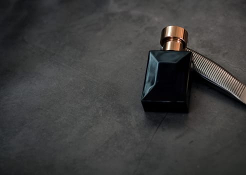 Men's fragrance. Perfume bottle on dark grungy background