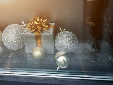 balls and gifts in the shop window. christmas decor