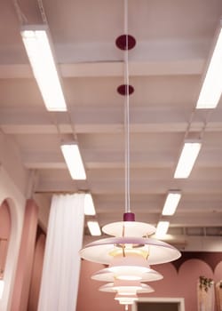a row of glowing pendant lights in the apartment.