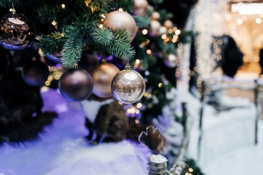 Closeup of bauble hanging from a decorated Christmas tree