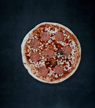 pepperoni pizza on a dark background. traditional italian food