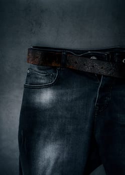 part of black stylish men's jeans with a leather belt