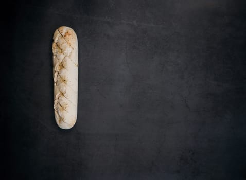 Sliced bread over dark stone background. View from above with copy space