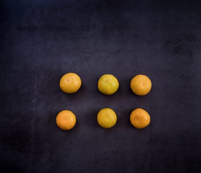 healthy eating. ripe yellow tangerines on a dark background. place for text. christmas mood
