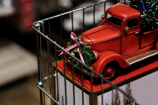 Red small retro toy truck on shop. christmas toy