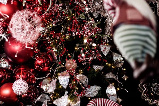 Vintage red baubles christmas tree. garlands in the background. New Year concept.