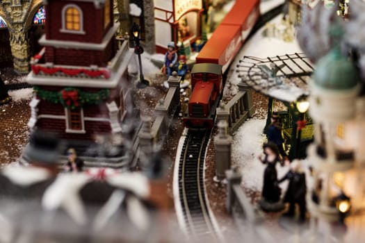 Minsk, Belarus, December 2021 - miniature model of a city with houses and a railway station. Narrow focus field. christmas time