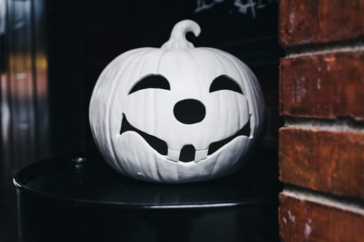 white ceramic pumpkin for Halloween at the entrance to the cafe