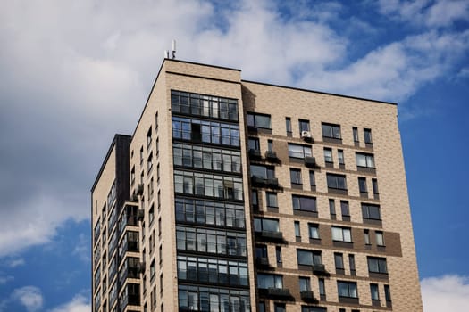 new brick apartment building with blue sky background. european architecture