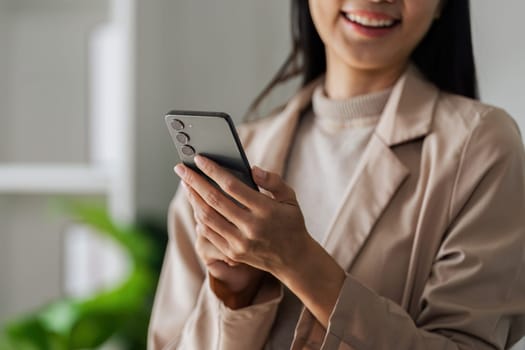 Business woman relax with mobile and look out window during work.